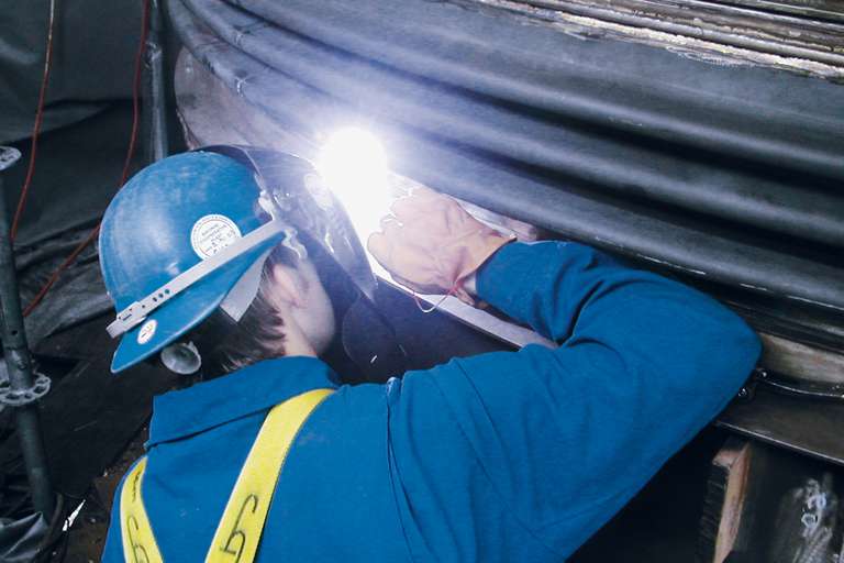 Clamshell expansion joint to protect a damaged metal bellows